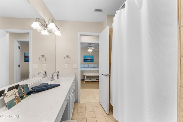 bathroom with tile patterned floors, ceiling fan, curtained shower, and vanity