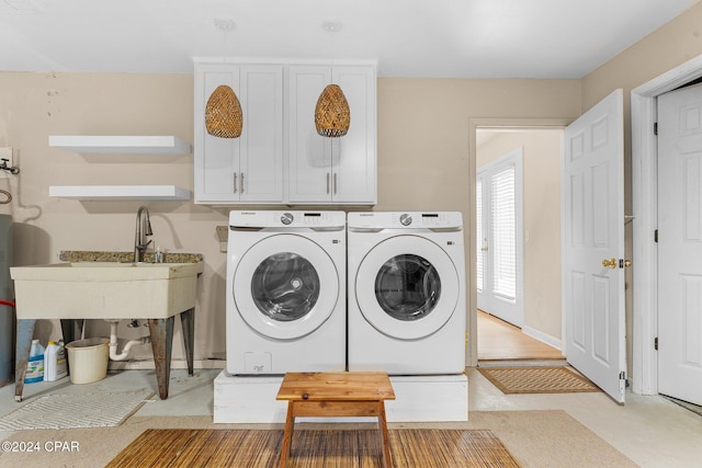 laundry room featuring cabinets and washing machine and dryer