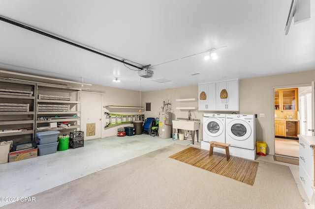 garage with separate washer and dryer, sink, a garage door opener, and water heater