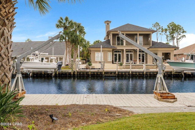 view of dock featuring a water view and a balcony