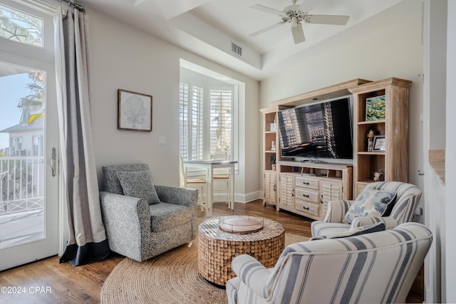 living area featuring ceiling fan, a healthy amount of sunlight, and wood-type flooring