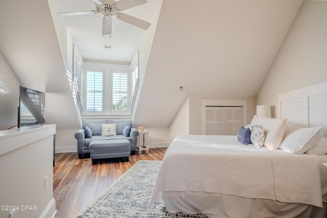 bedroom featuring wood-type flooring, high vaulted ceiling, a closet, and ceiling fan