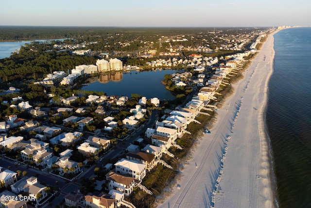 bird's eye view featuring a water view and a beach view