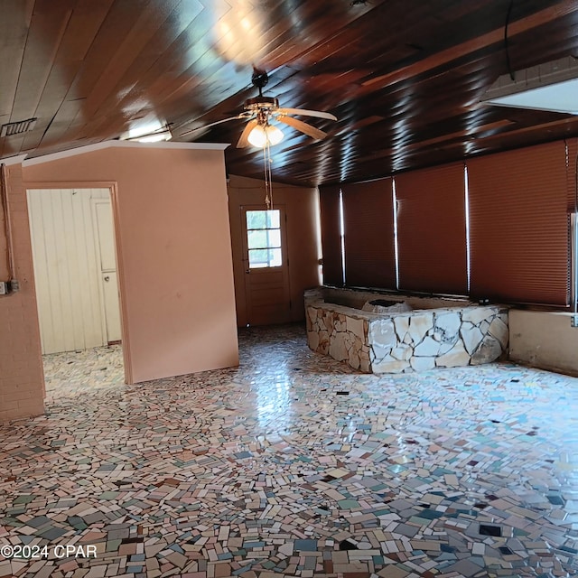 unfurnished room featuring ceiling fan, wood ceiling, and vaulted ceiling