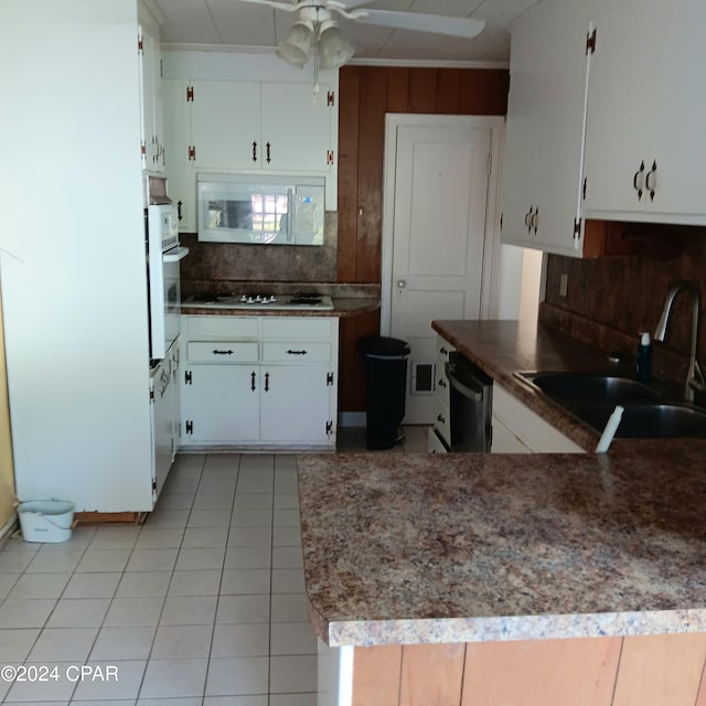 kitchen featuring white cabinetry, sink, and white appliances