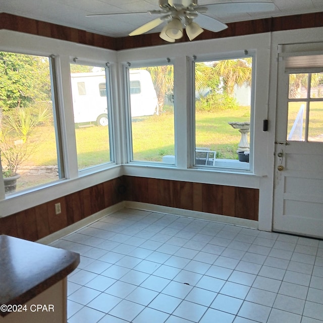 unfurnished sunroom featuring a wealth of natural light and ceiling fan