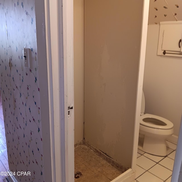 bathroom featuring toilet and tile patterned floors