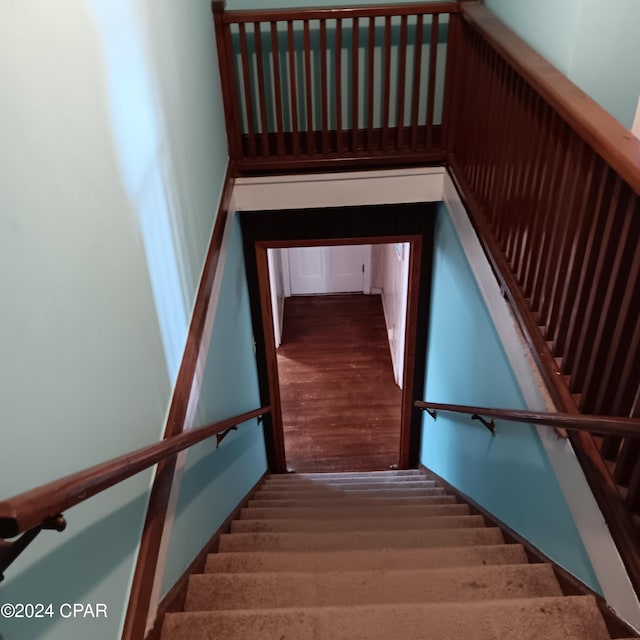 staircase with wood-type flooring