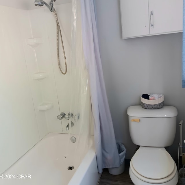 bathroom with shower / bath combo and toilet