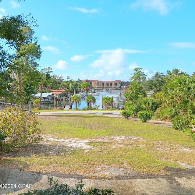 surrounding community featuring a yard and a water view