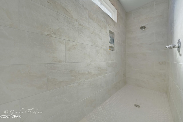 bathroom with a tile shower