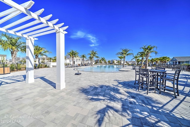 view of swimming pool with a pergola and a patio