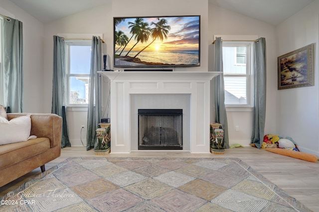 living area with light hardwood / wood-style floors and lofted ceiling