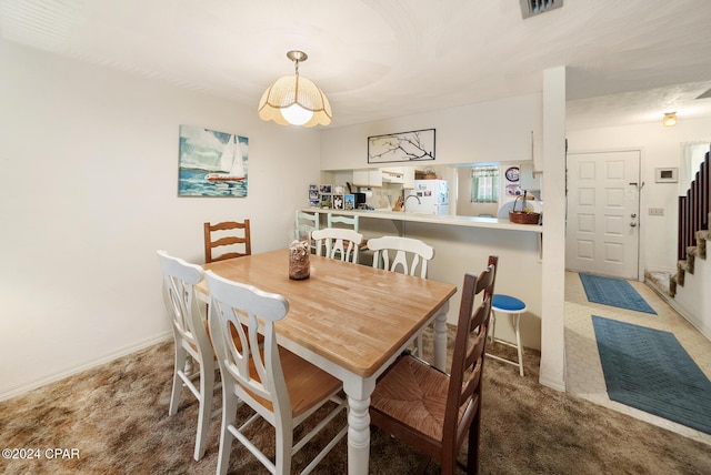 dining space featuring carpet flooring