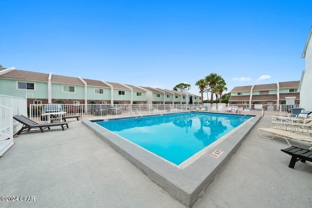 view of swimming pool with a patio