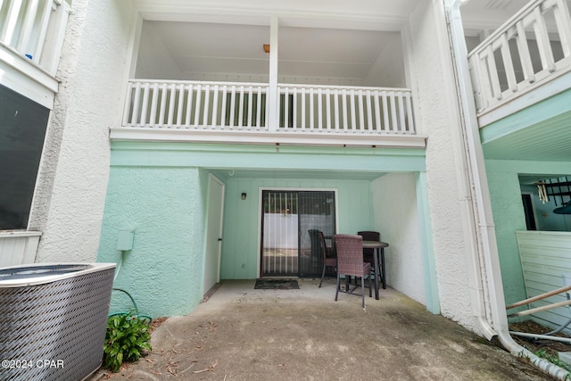 entrance to property with a balcony and central AC