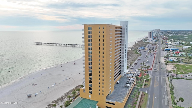 drone / aerial view featuring a water view and a view of the beach