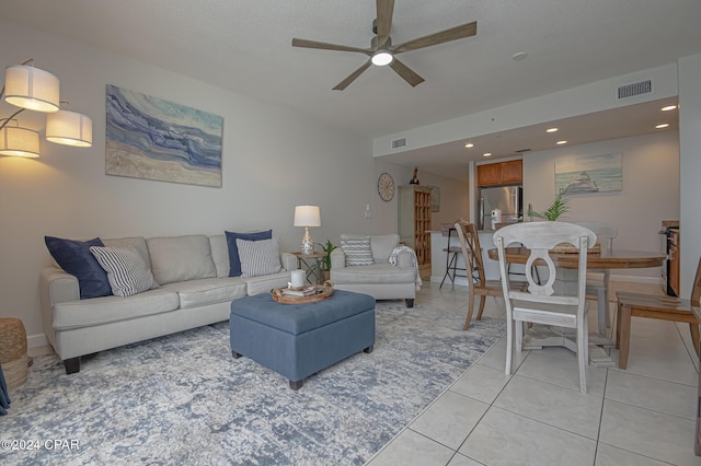 tiled living room featuring ceiling fan