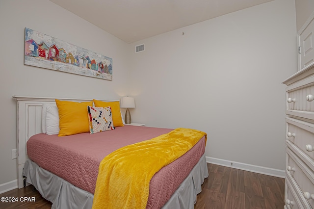 bedroom with dark hardwood / wood-style floors