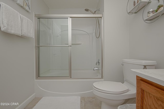 full bathroom featuring tile patterned floors, vanity, toilet, and bath / shower combo with glass door