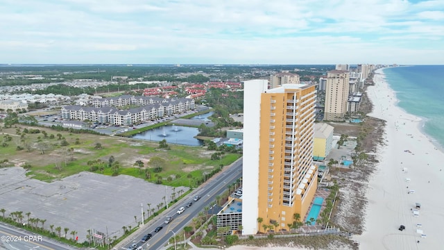 drone / aerial view featuring a water view and a view of the beach