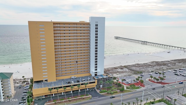 view of property with a water view and a view of the beach