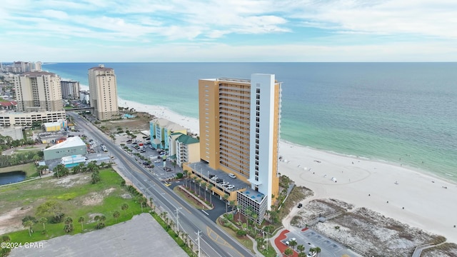 drone / aerial view featuring a water view and a beach view