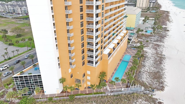 view of building exterior featuring a view of the beach and a water view