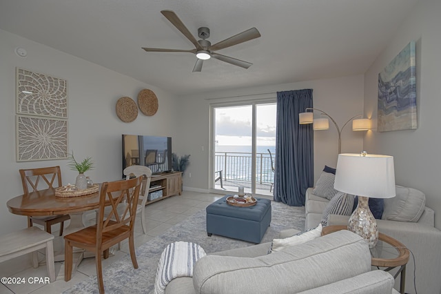 living room featuring light tile patterned floors and ceiling fan