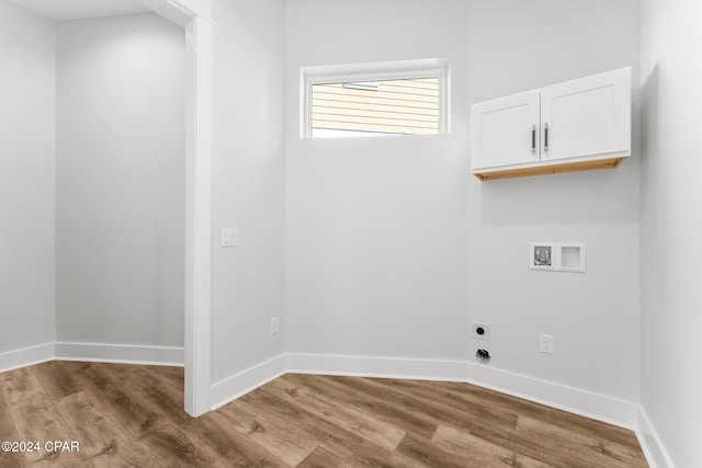 laundry area featuring cabinets, washer hookup, hardwood / wood-style floors, and electric dryer hookup