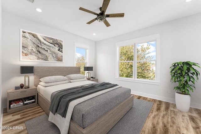 bedroom with wood-type flooring and ceiling fan