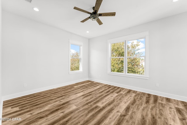 spare room with hardwood / wood-style flooring and ceiling fan