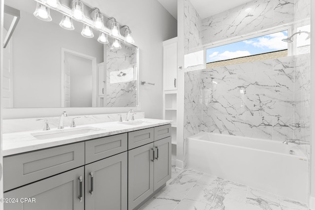 bathroom featuring vanity and tiled shower / bath