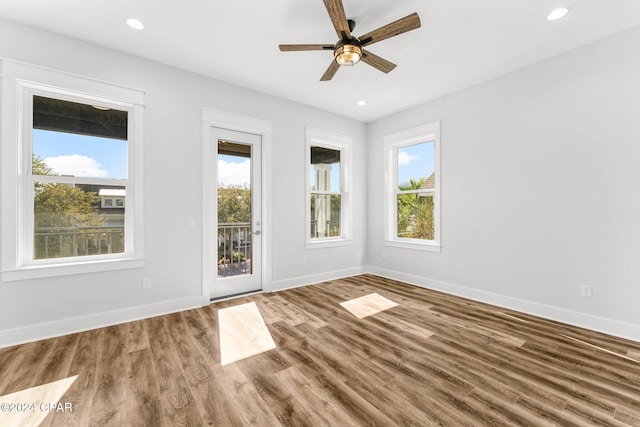 unfurnished room with hardwood / wood-style flooring and ceiling fan