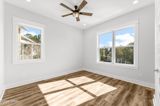 unfurnished room featuring dark wood-type flooring and ceiling fan