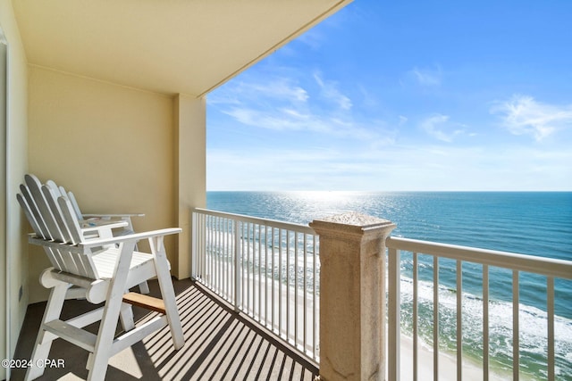 balcony with a water view and a beach view