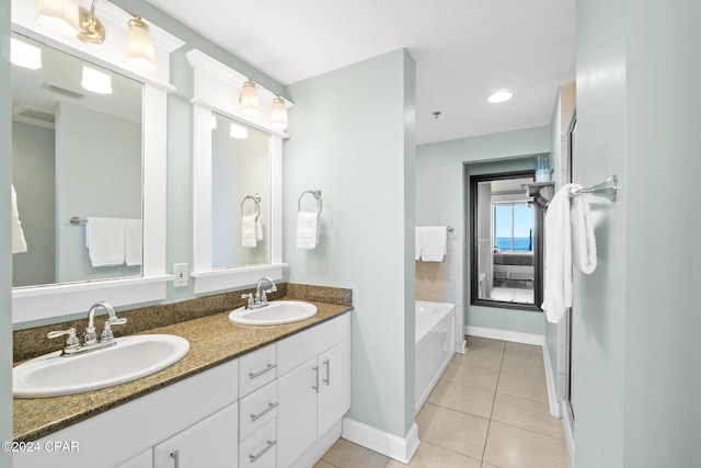 bathroom with vanity, tile patterned floors, and a tub