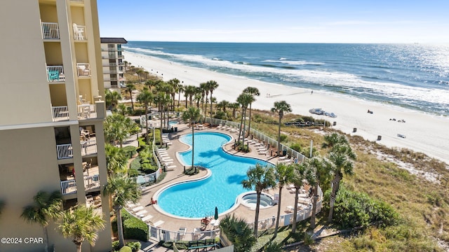 view of pool featuring a view of the beach and a water view