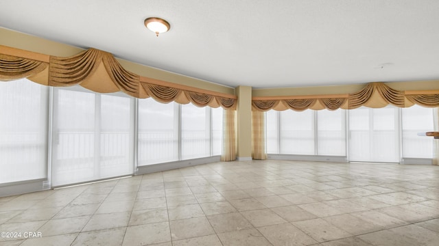 empty room with light tile patterned flooring