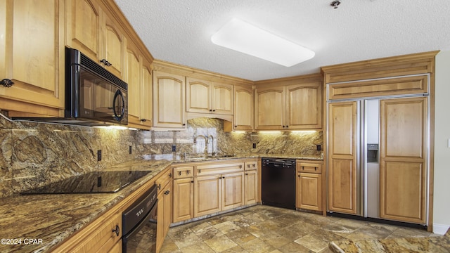 kitchen with black appliances, sink, decorative backsplash, dark stone countertops, and a textured ceiling