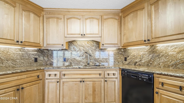 kitchen with decorative backsplash, light stone countertops, sink, and black dishwasher