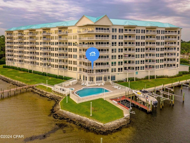 outdoor building at dusk with a water view and a community pool