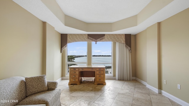 unfurnished room with a textured ceiling and a water view