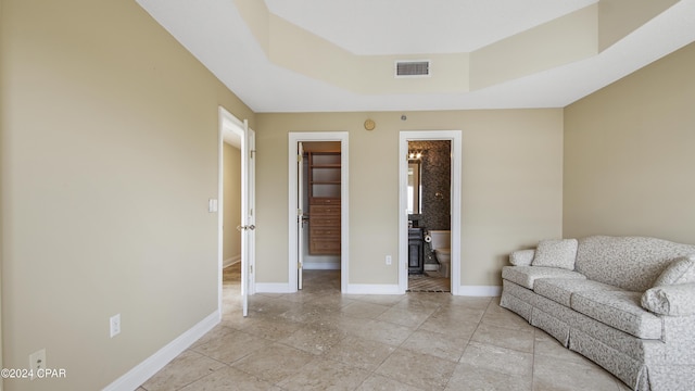 living area with a tray ceiling