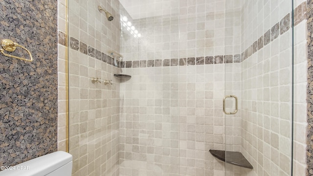 bathroom featuring an enclosed shower and toilet