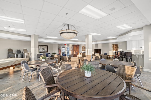 dining space featuring a drop ceiling