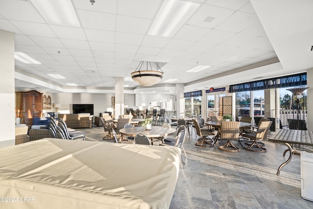 interior space with a paneled ceiling