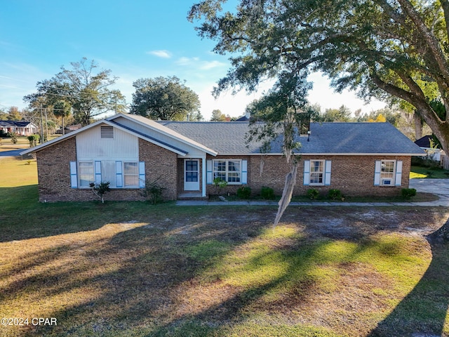 ranch-style home with a front lawn