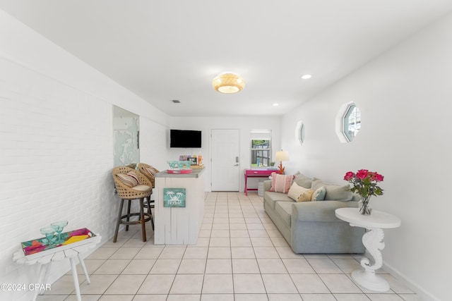 living area featuring light tile patterned flooring, visible vents, and recessed lighting