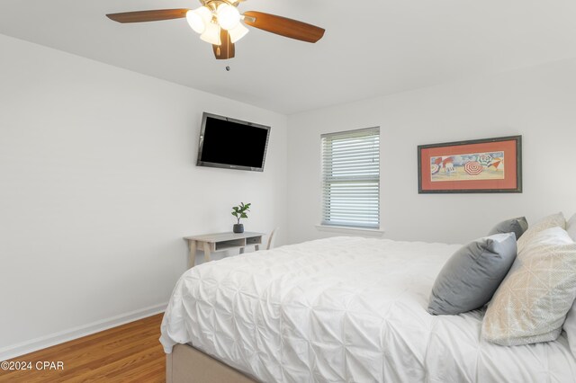 bedroom with ceiling fan and wood-type flooring